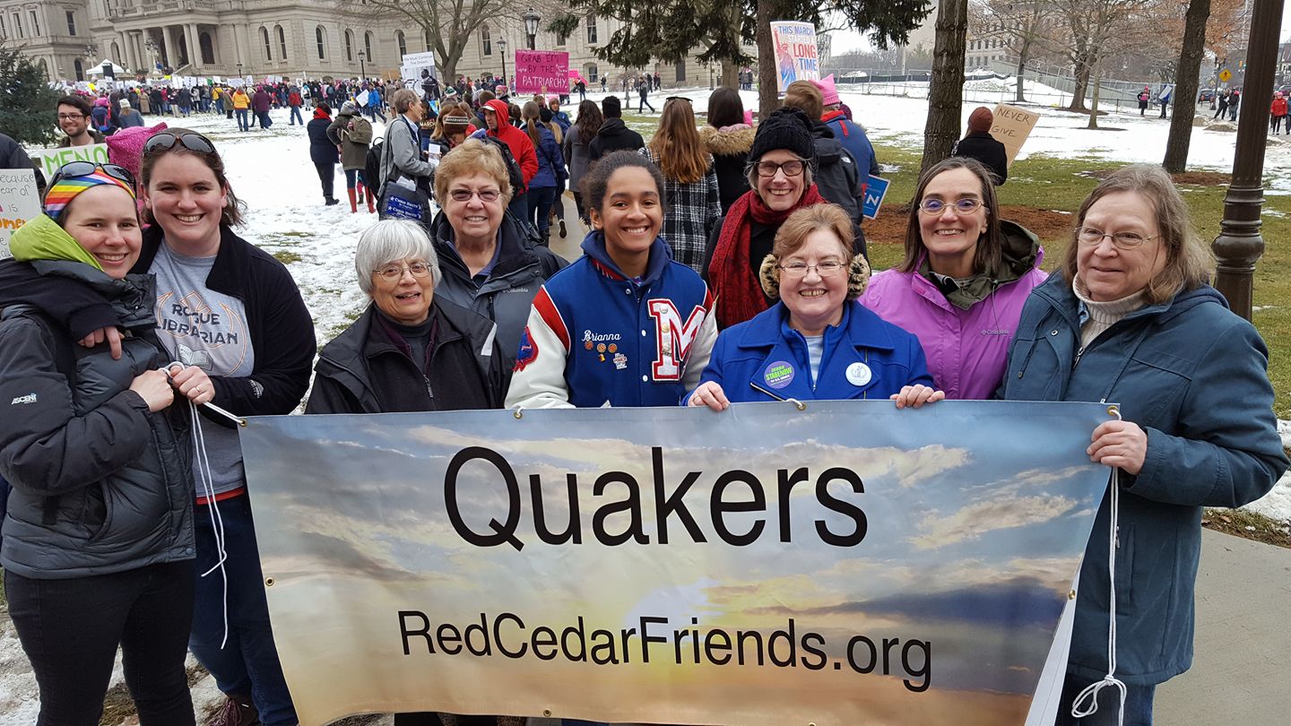 Quaker contingent holding banner at the Lansing Women's March, 2018